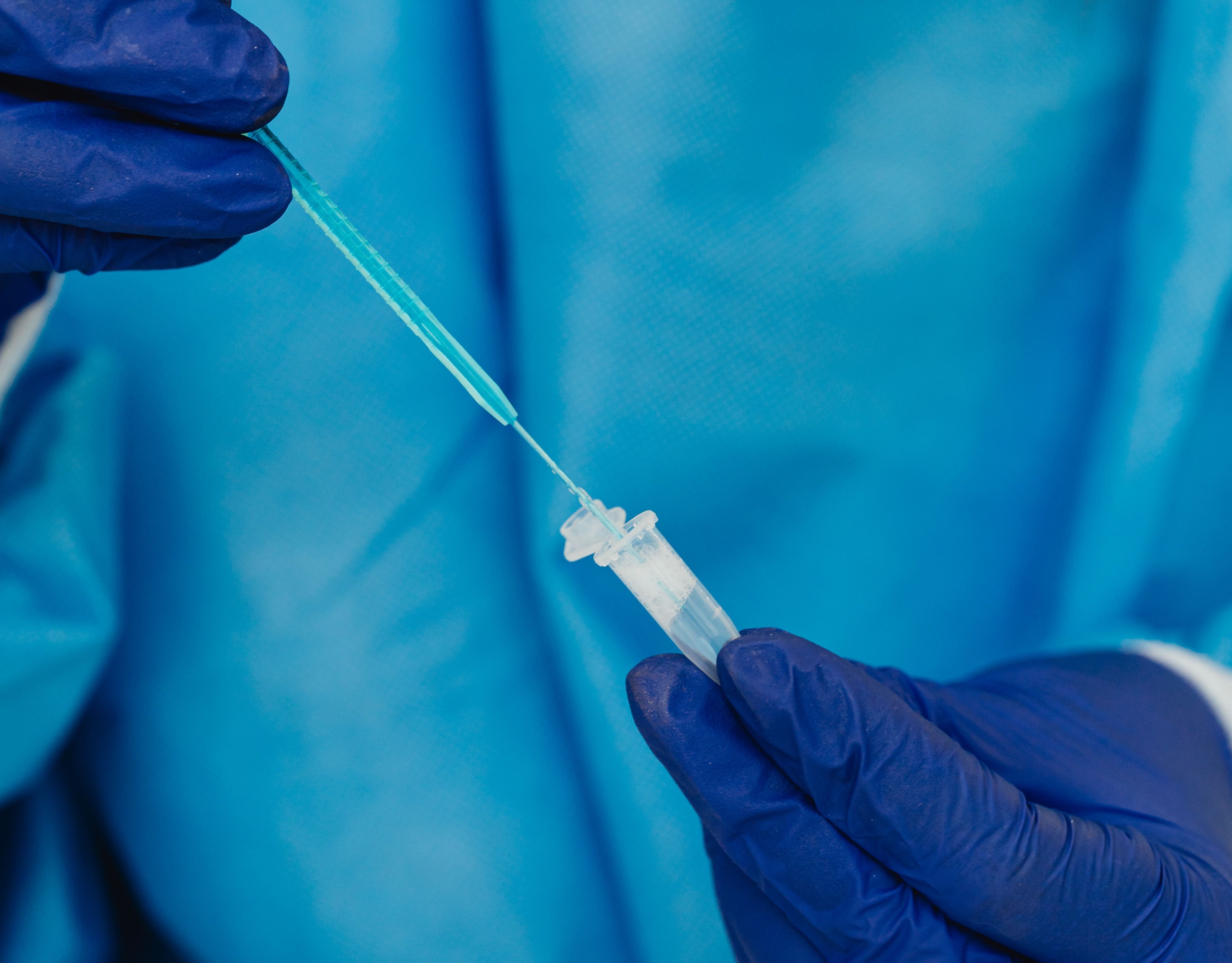 scientist pipeting a monoclonal antibody in a mixture for its characterization 